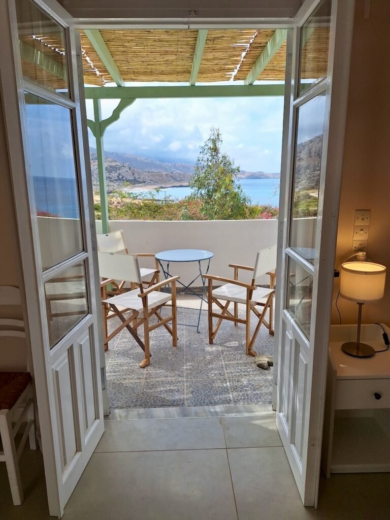 Room doorway opening to a private sea-view balcony